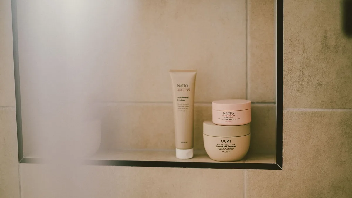 Modern bathroom shelf holding haircare bottles