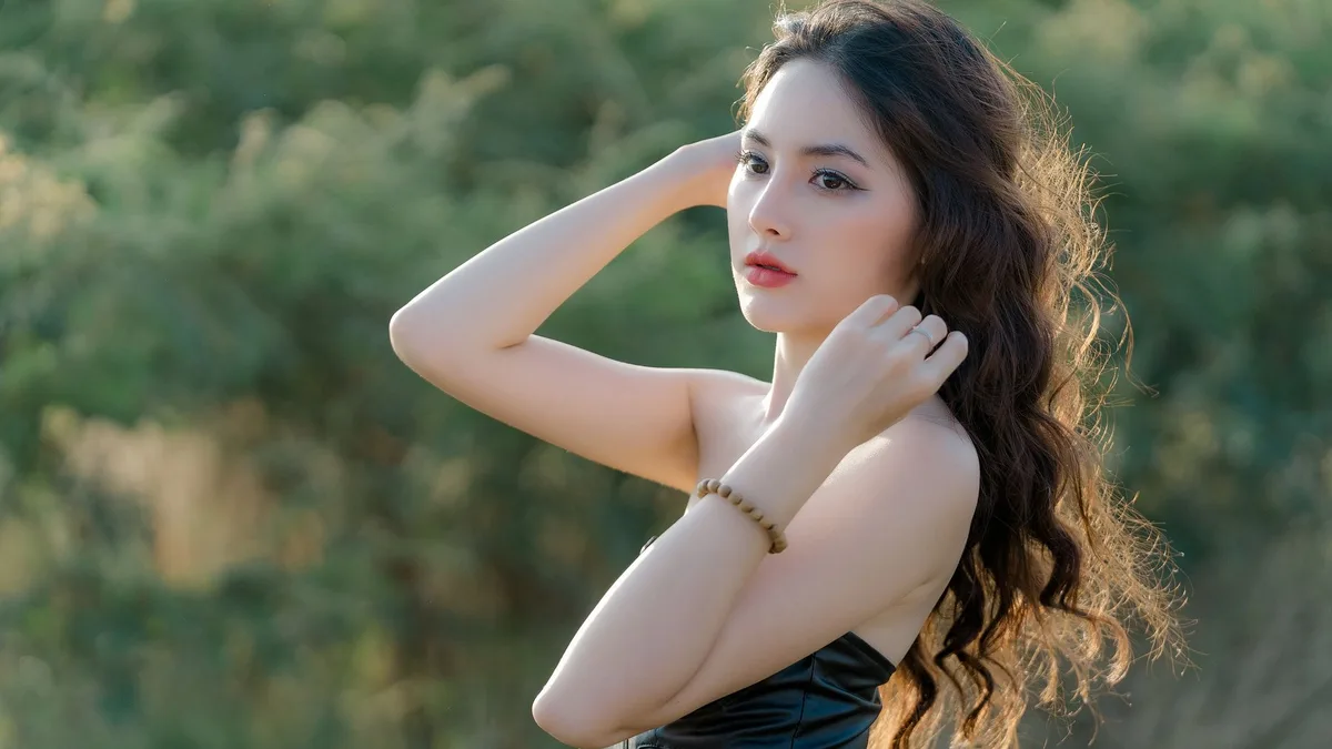 Woman with long lightened hair photographed outdoors