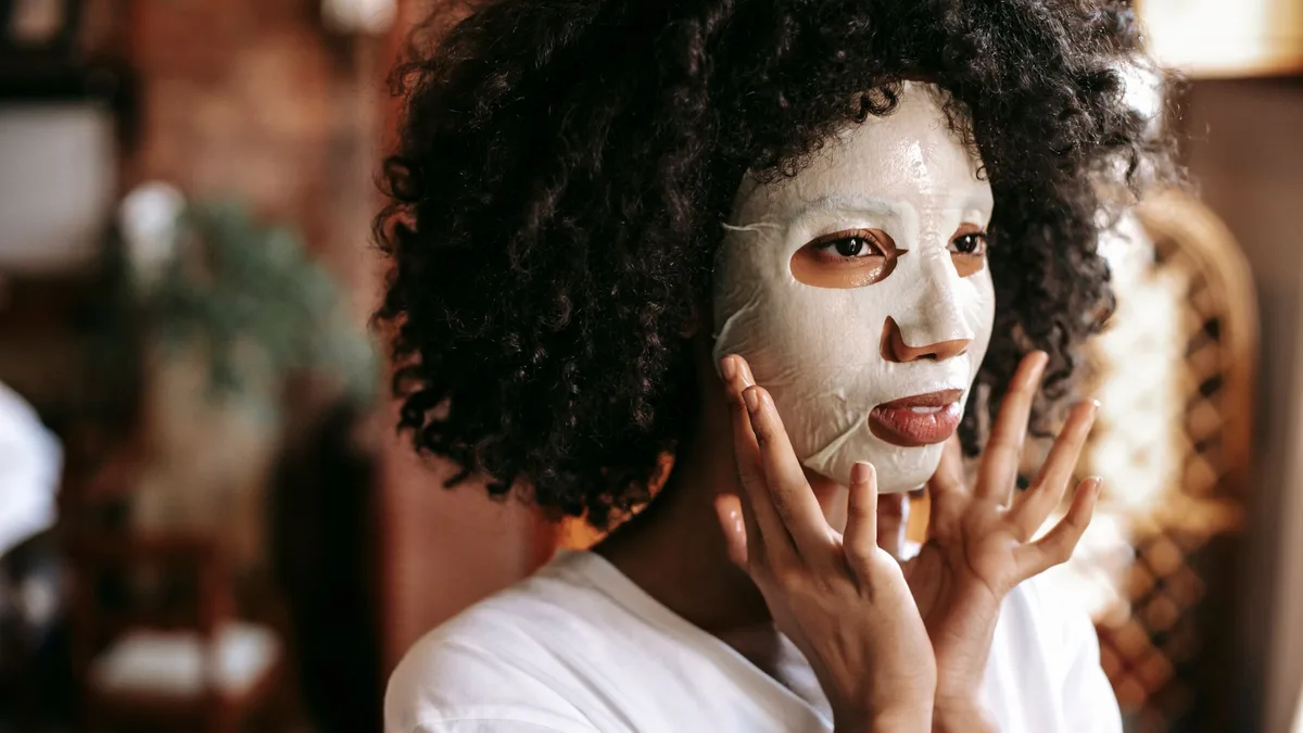 Woman applying a conditioning treatment to her hair