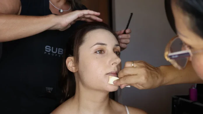 Woman having her base makeup applied
