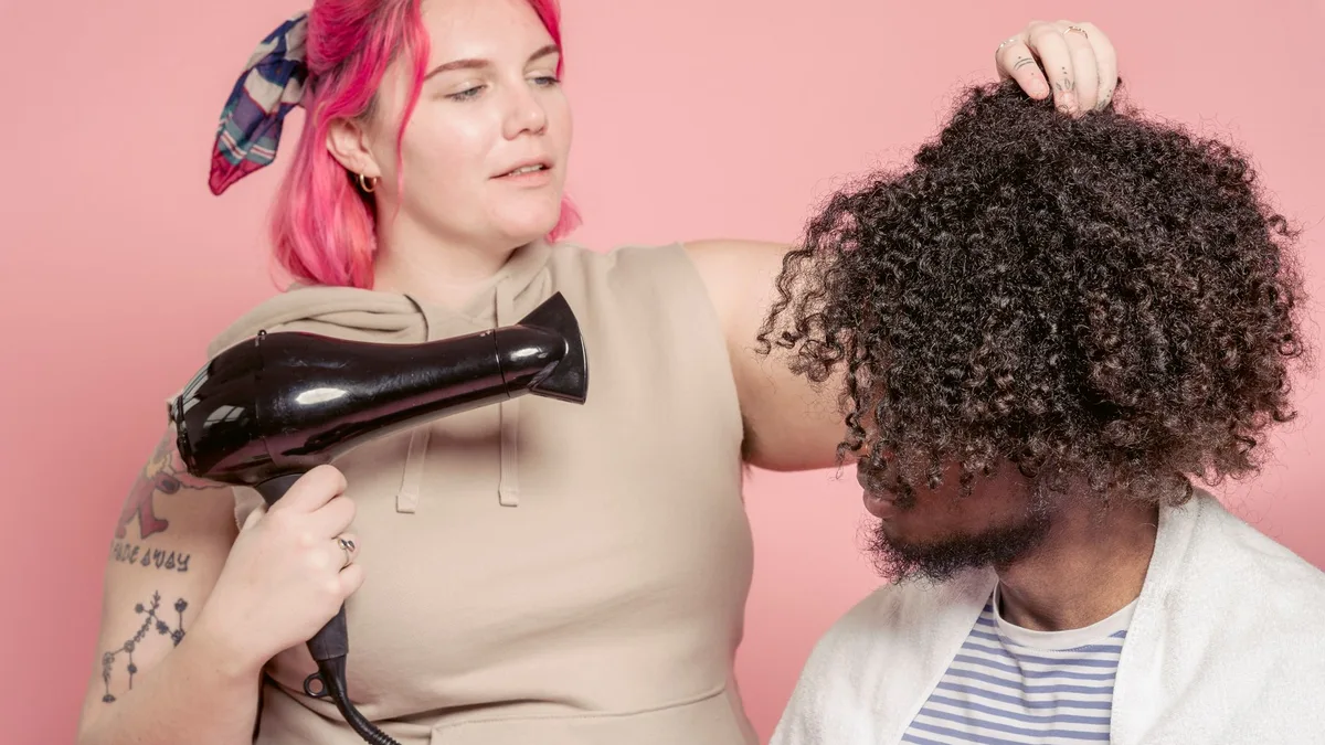 Hairdresser drying textured curly hair