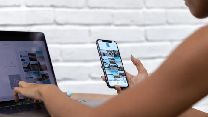 Woman using a laptop and smartphone, blue light exposure
