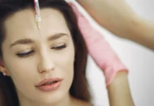 Botox: How It Works, Longevity and Questions to Ask Woman receiving a cosmetic forehead injection in a clinic
