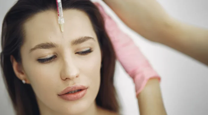 Botox: How It Works, Longevity and Questions to Ask Woman receiving a cosmetic forehead injection in a clinic