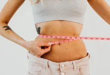CoolSculpting and EMSculpt: Non-Surgical Body Contouring Compared Woman measuring her waist, body contouring