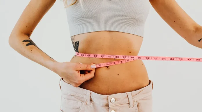 CoolSculpting and EMSculpt: Non-Surgical Body Contouring Compared Woman measuring her waist, body contouring