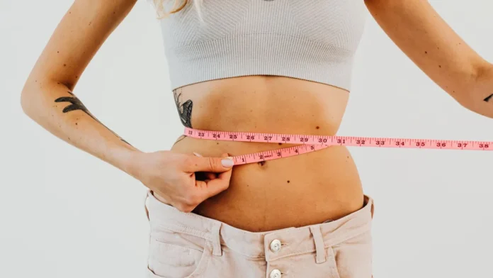 Non-Surgical Body Contouring Woman measuring her waist, body contouring