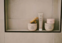 Curl Defining Cream: How to Choose One for Your Curl Type Curl defining cream and hair products on a bathroom shelf