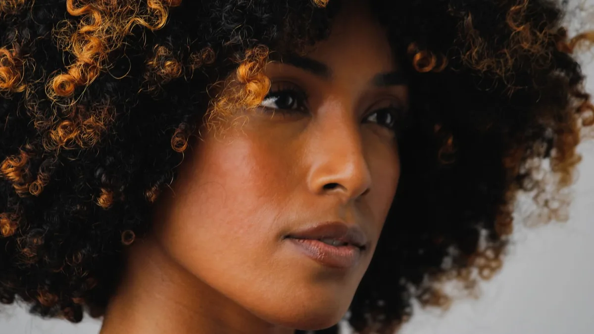 Close-up portrait of a woman with voluminous coily hair