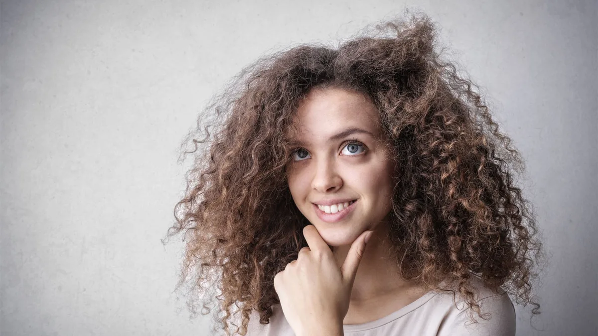 Smiling woman with voluminous curly hair
