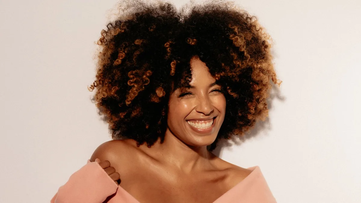 Cheerful woman with a full curly afro hairstyle