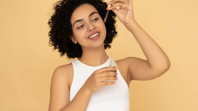 Curl Revival Products Woman with curly hair applying a revival hair serum