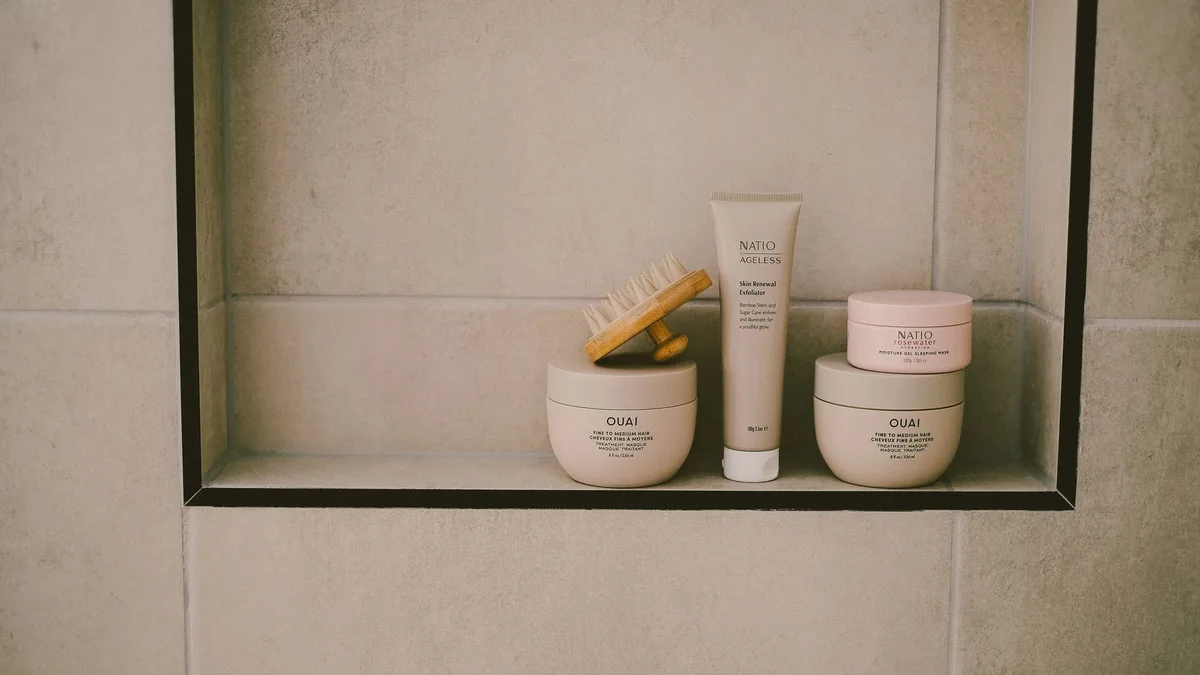 Minimalist bathroom shelf with haircare bottles and jars