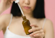 Dark Spot Treatments for Post-Acne Marks Applying a dark spot treatment serum to the face
