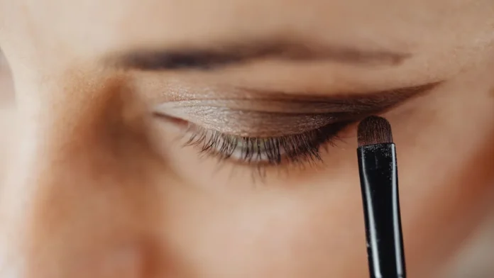 Eye makeup being applied with a brush, close-up