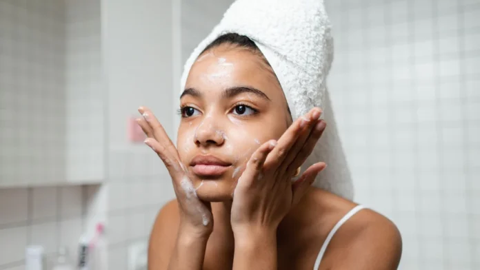 Woman cleansing her face as part of a skincare routine