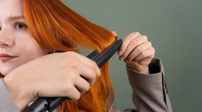 Flat Iron vs Curling Iron: Which One Should You Actually Buy? Woman styling her hair with a flat iron straightener