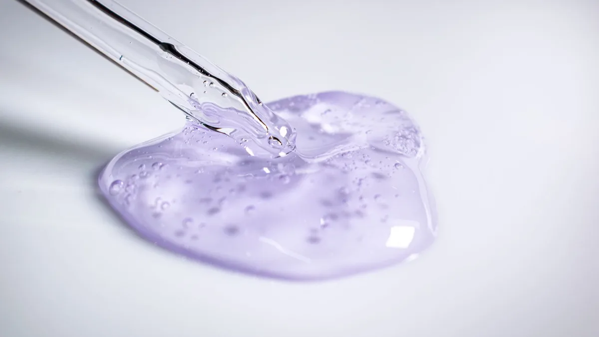 Clear styling gel being dispensed onto a surface