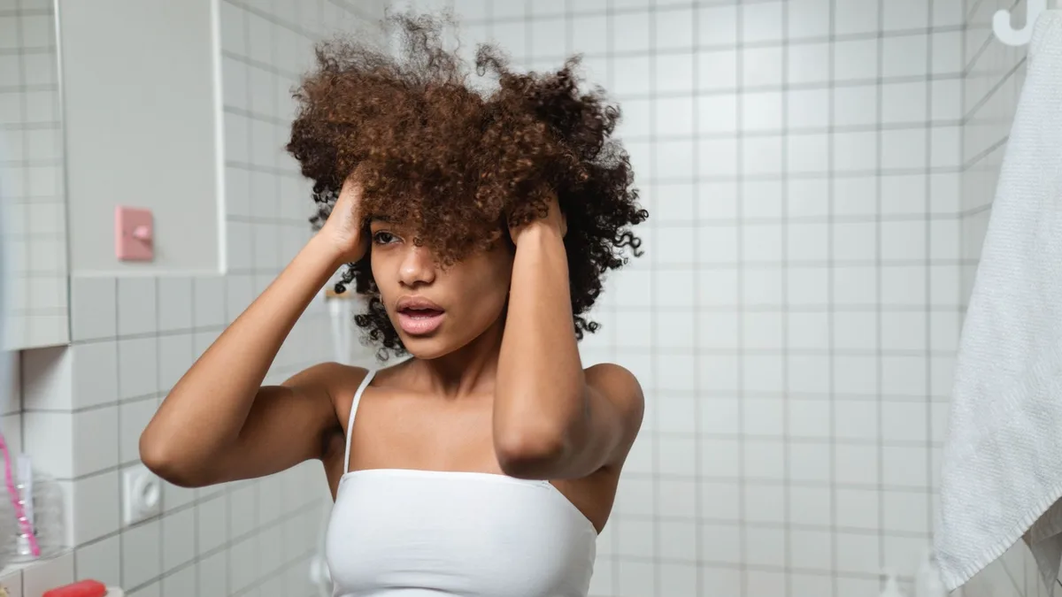 Woman with wet curly hair beginning her morning routine