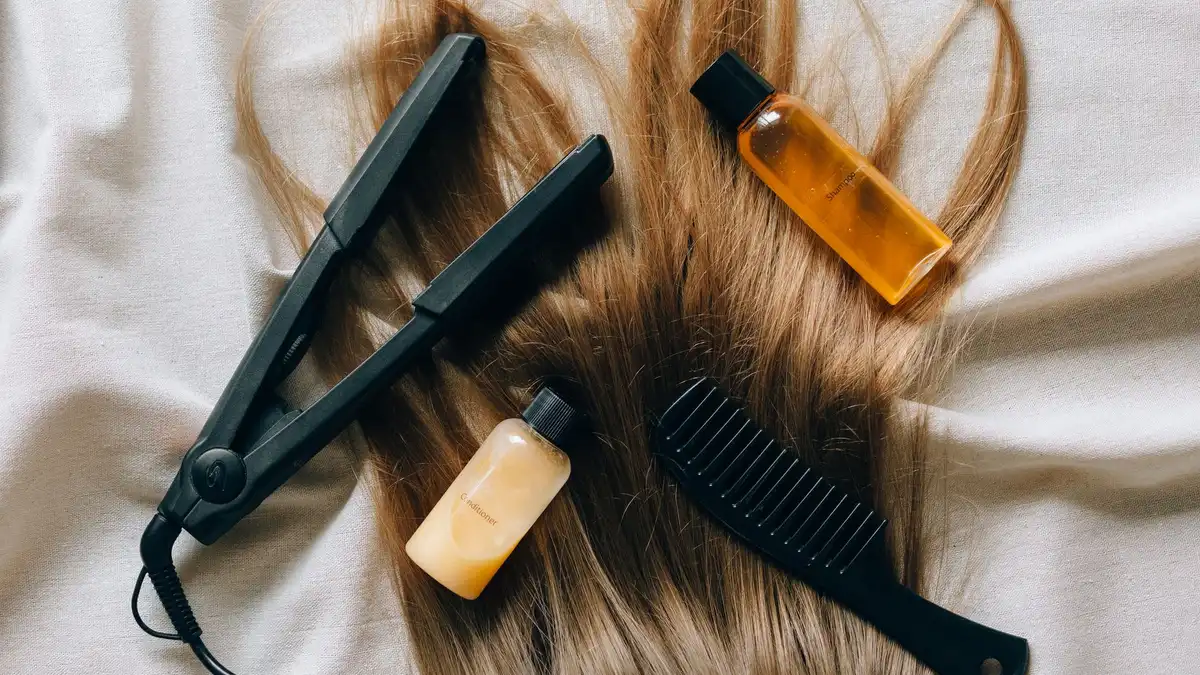 Flat lay of hair styling products and tools