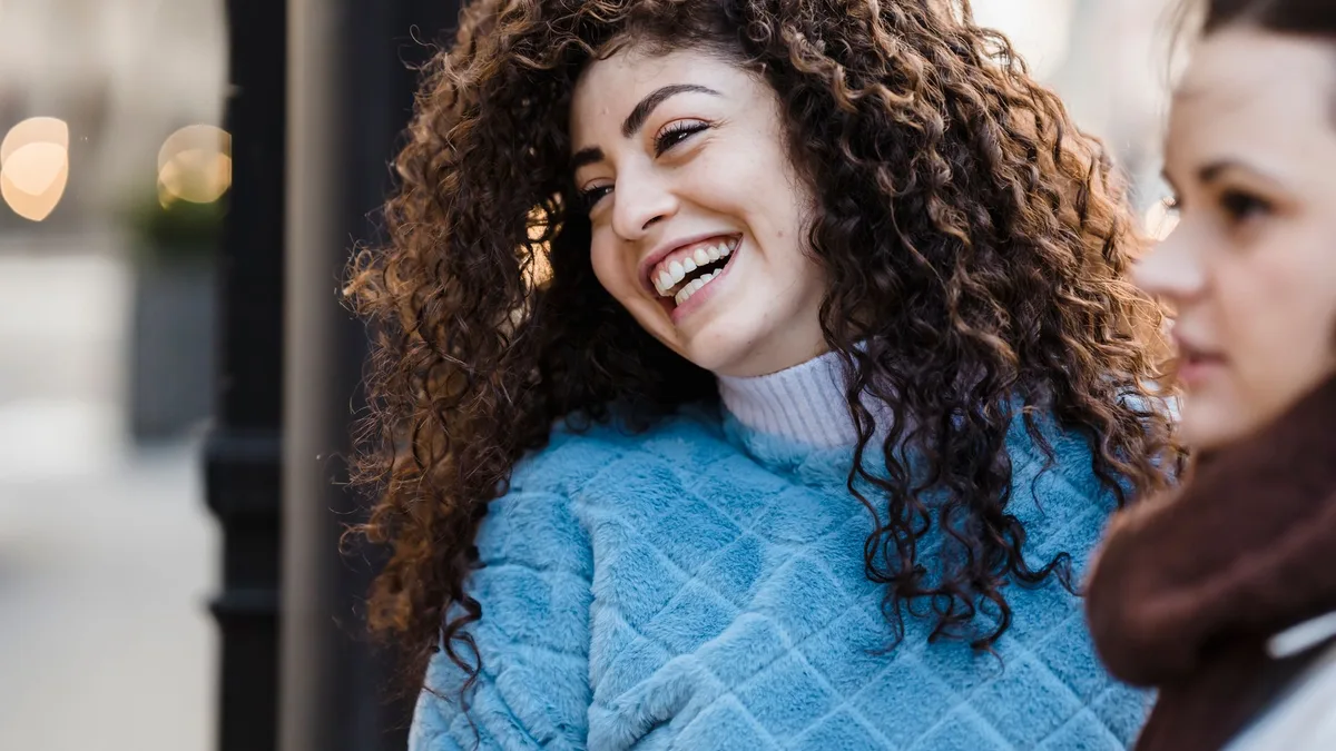 Laughing woman with long defined curly hair