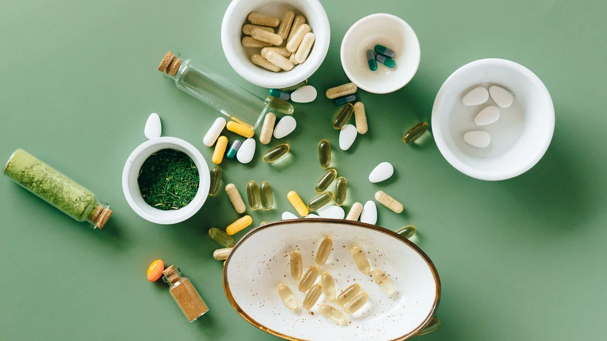 Assorted supplement capsules and tablets in small bowls