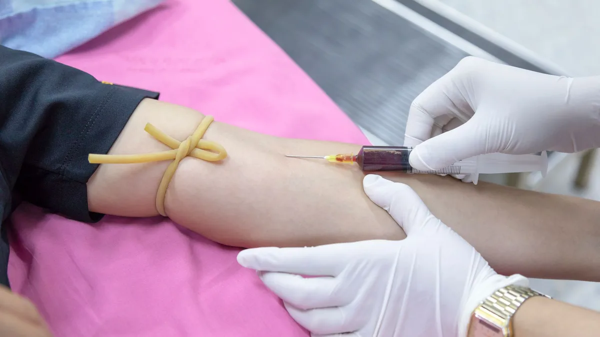 Healthcare professional taking a blood sample from a patient