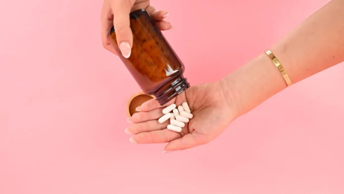 Hair Supplements Hair growth supplement capsules from a bottle