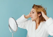 Hair Loss Treatment for Women: Causes, Blood Tests and What the Evidence Shows Woman checking her hair in a mirror