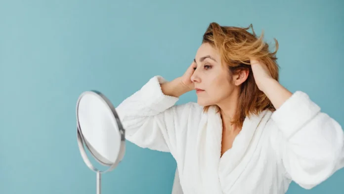 Hair Loss Treatment for Women Woman checking her hair in a mirror