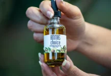 Hair Regrowth Serum: Licensed Medicine or Cosmetic? How to Tell Hand holding a hair regrowth scalp serum bottle