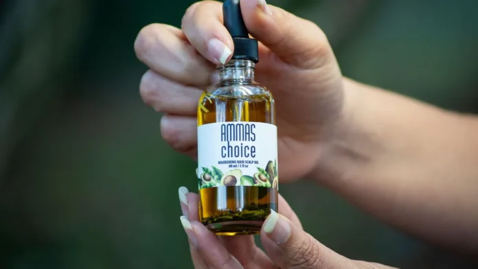 Hair Regrowth Serums Hand holding a hair regrowth scalp serum bottle