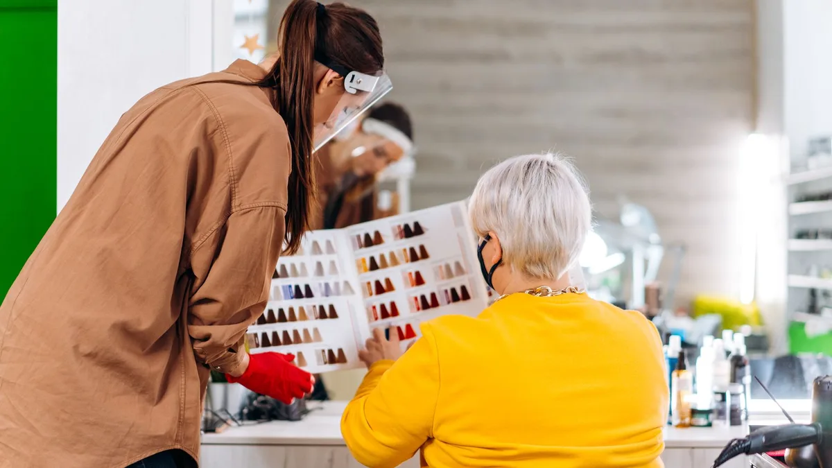Stylist consulting with a client in a salon