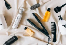Hair Styling Tools: A Complete Buyer’s Guide to Heat Styling Flat lay of hair styling tools including flat iron, brush and sprays