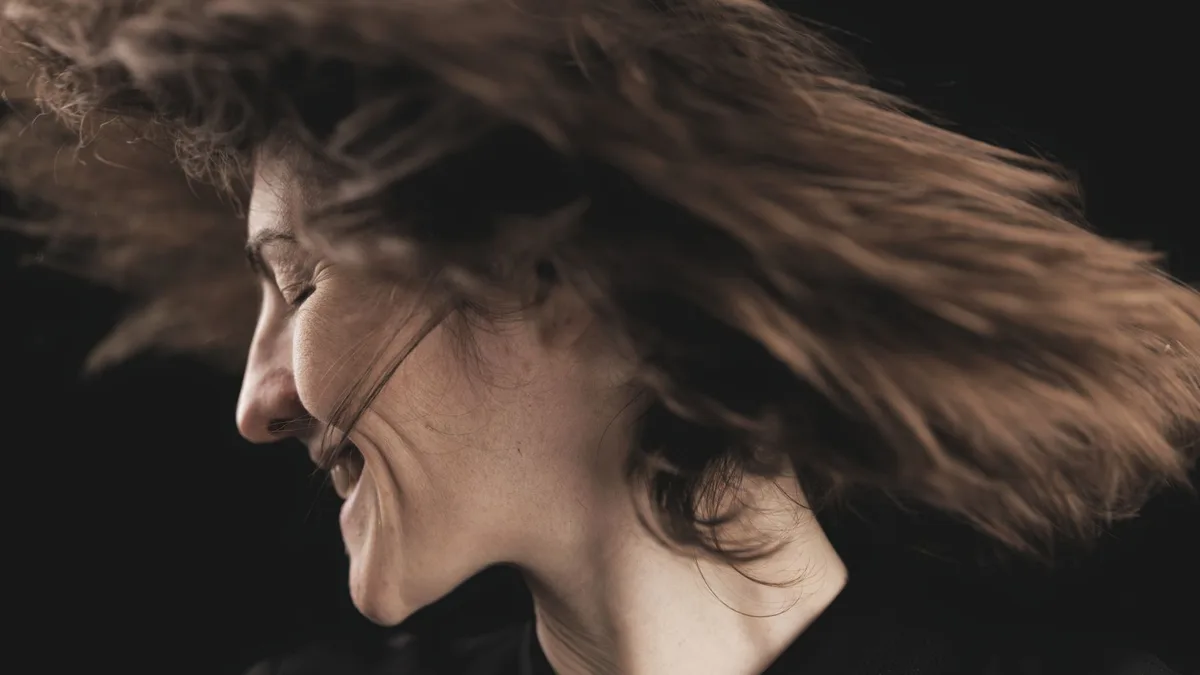 Woman flipping her hair with a joyful smile