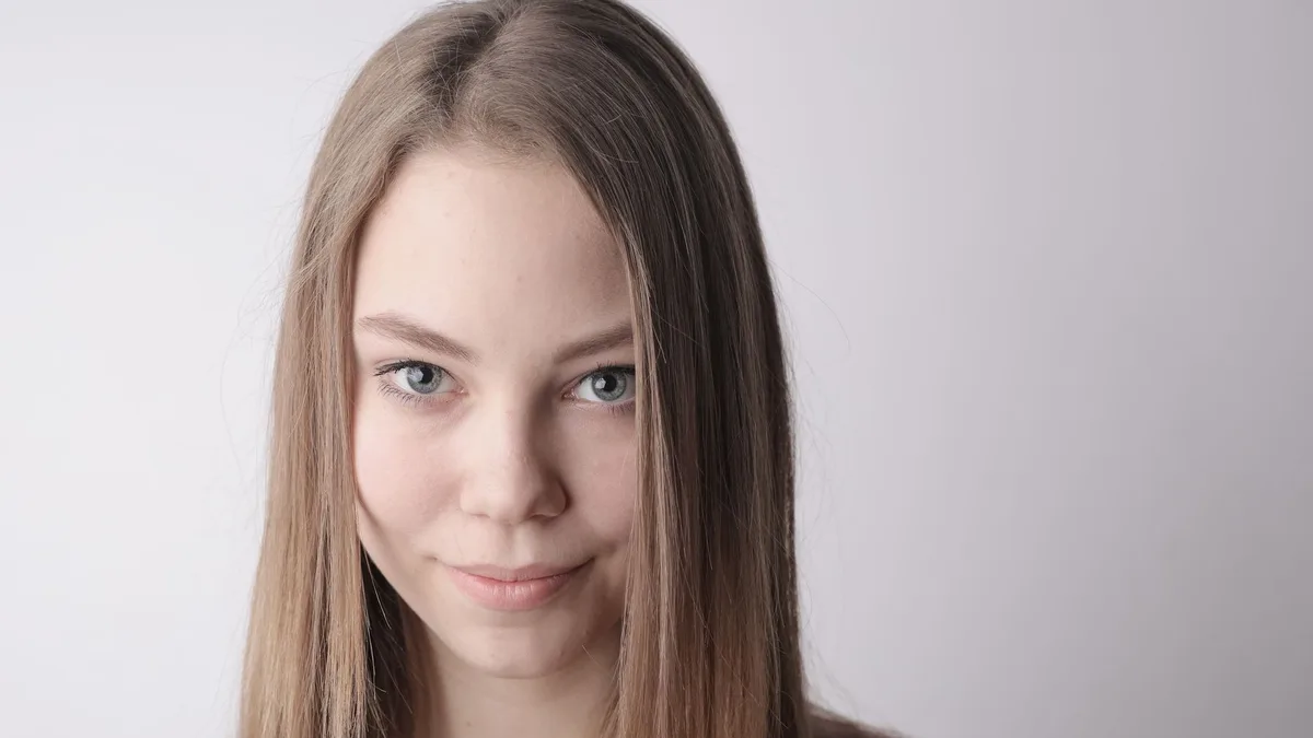 Smiling young woman with natural looking hair