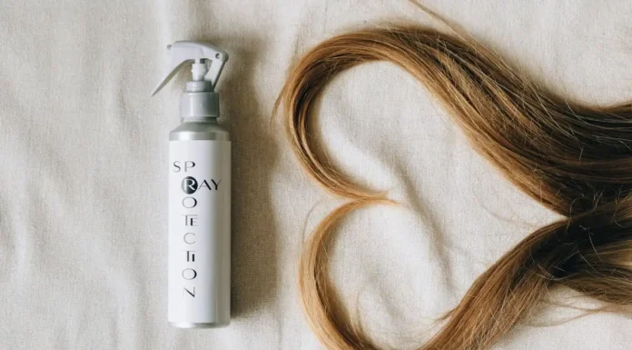 Heat Protectant Spray: What It Really Does, and How Much to Use Heat protectant hair spray bottle beside styled hair