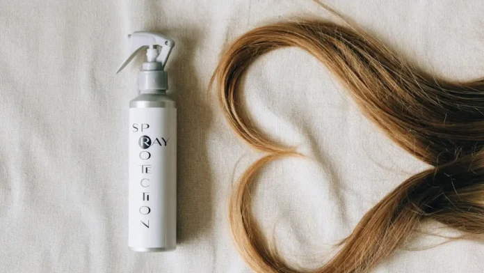 Heat Protectant Spray Heat protectant hair spray bottle beside styled hair