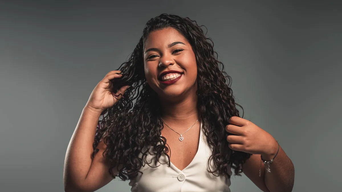 Smiling woman with bouncy voluminous curls