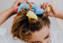 Heatless Curls: Rollers, Rods and Overnight Methods That Work Woman using colourful foam rollers for heatless curls
