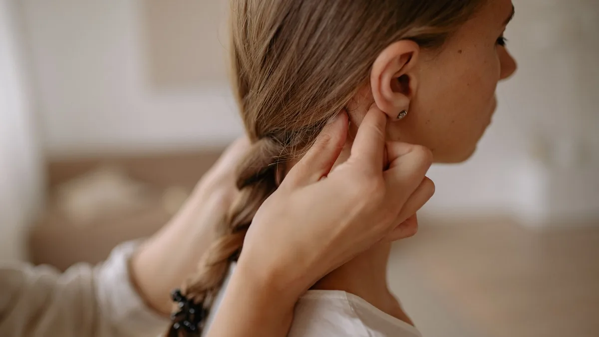 Close-up of hair being braided into a neat plait