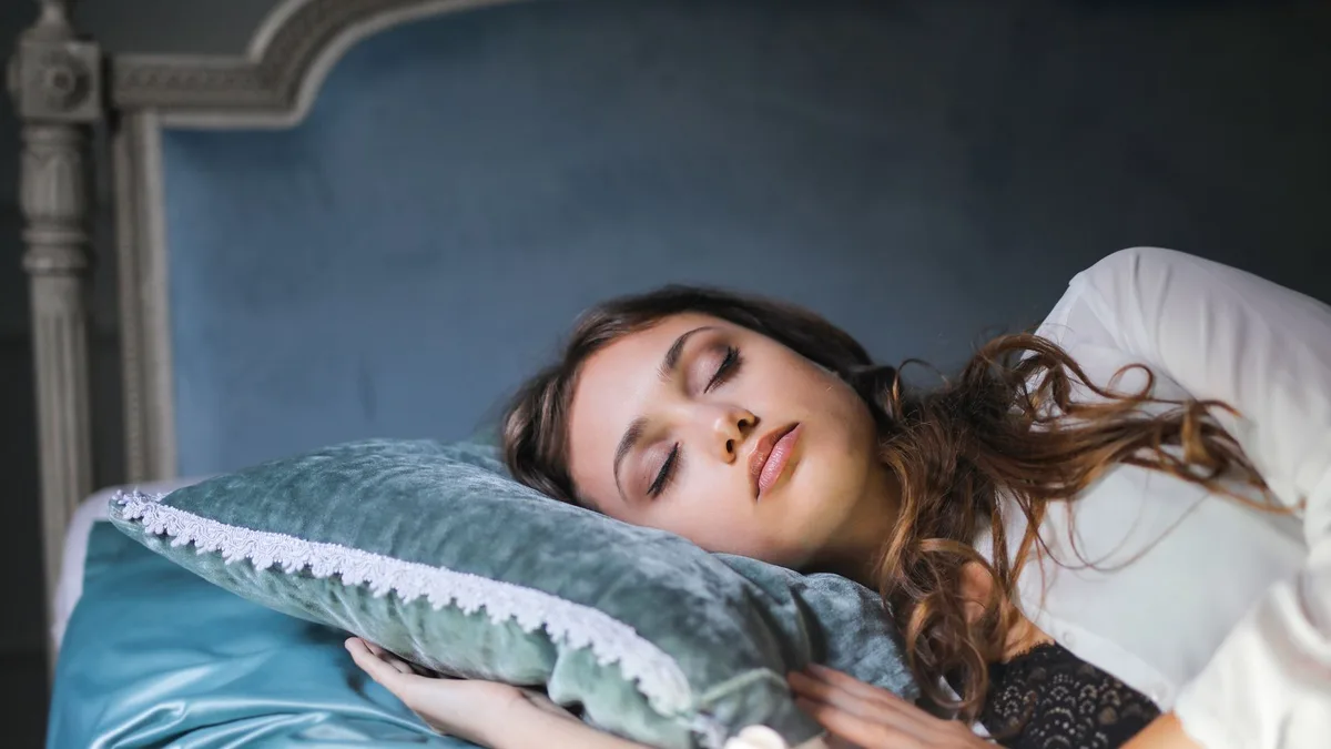 Woman sleeping peacefully with her hair spread on a pillow