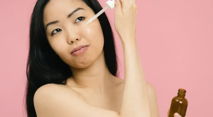 Korean Skincare Routine: The Layering Method Explained Woman applying skincare serum for glowing skin