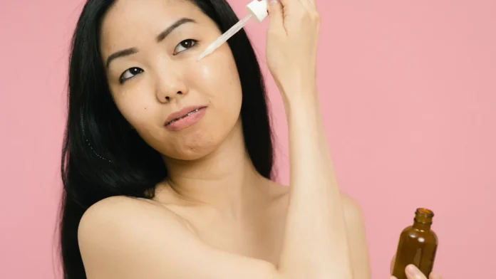 Korean Skincare Routine Woman applying skincare serum for glowing skin