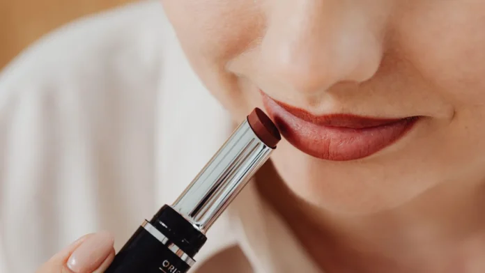 Lip Care and Lip Makeup Woman applying lipstick, close-up