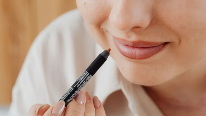 Lip Liner Woman applying lip liner, close-up