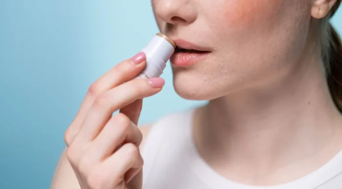 Lip Scrubs and Exfoliators: Prepping Lips for Matte Colour Woman applying lip balm after a lip scrub