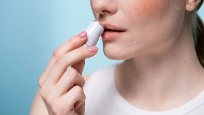 Lip Scrubs Woman applying lip balm after a lip scrub