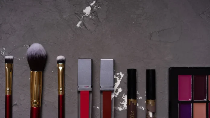 Flat lay of makeup brushes and cosmetics