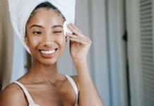 Makeup Removers and Wipes: When They Help and When They Hurt Woman removing makeup with a cotton pad